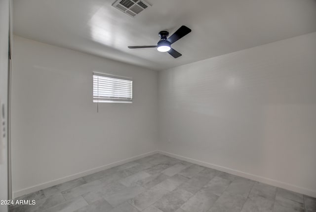 tiled empty room with ceiling fan