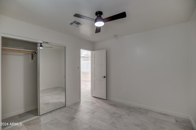 unfurnished bedroom with ceiling fan, a closet, and light tile floors