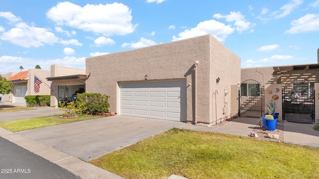 pueblo-style house with a garage and a front yard