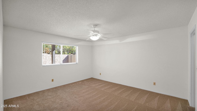 carpeted empty room featuring ceiling fan and a textured ceiling