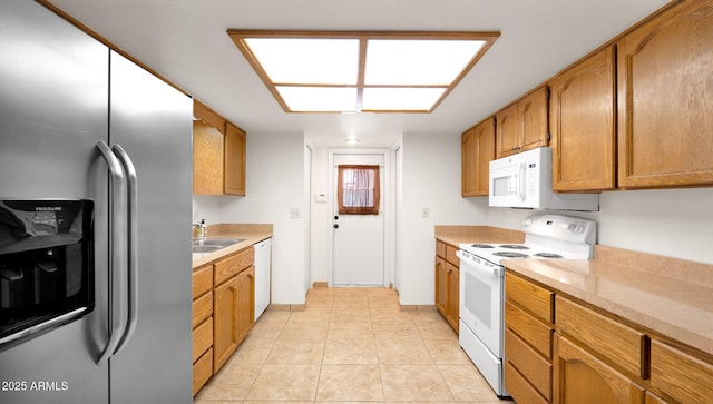 kitchen featuring sink, white appliances, and light tile patterned floors