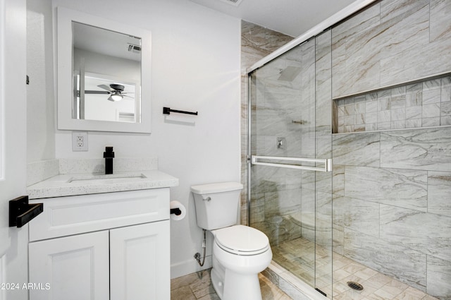 bathroom with ceiling fan, toilet, an enclosed shower, and vanity