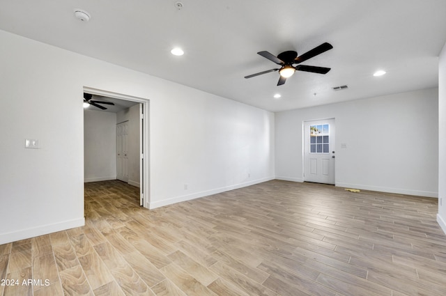 empty room with ceiling fan and light wood-type flooring