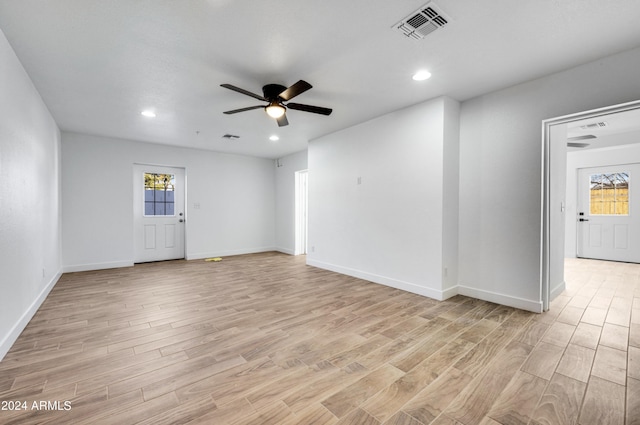 spare room featuring ceiling fan, plenty of natural light, and light hardwood / wood-style flooring