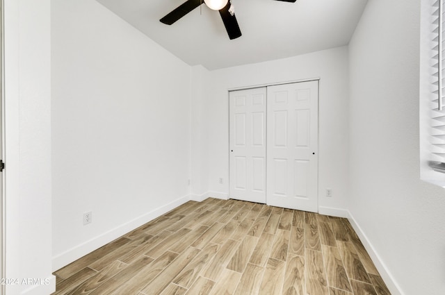 unfurnished bedroom with ceiling fan, a closet, and light hardwood / wood-style flooring