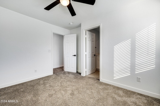 unfurnished bedroom with ceiling fan and light colored carpet