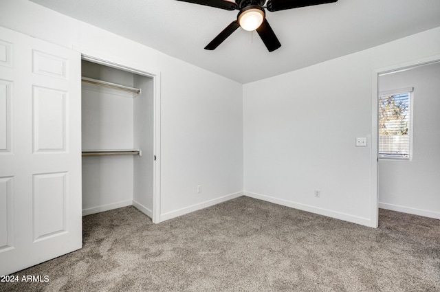 unfurnished bedroom featuring ceiling fan, a closet, and light colored carpet