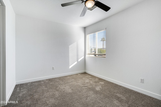 spare room with ceiling fan and carpet