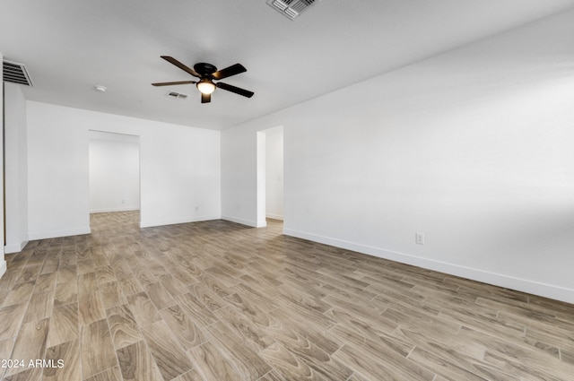 unfurnished room with light wood-type flooring and ceiling fan