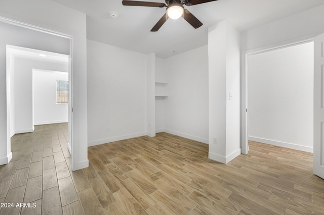 spare room with light hardwood / wood-style floors and ceiling fan