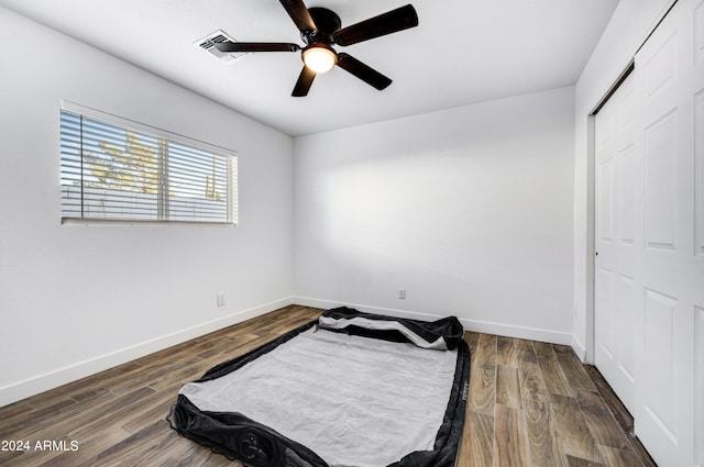 bedroom with a closet, ceiling fan, and hardwood / wood-style flooring