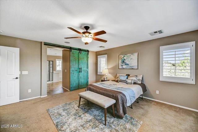 31133 N 132nd Ln, Peoria, AZ 85383 - bedroom featuring a barn door, carpet flooring, and ceiling fan