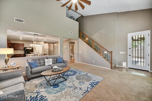 31133 N 132nd Ln, Peoria, AZ 85383 - living room with a ceiling fan, a towering ceiling, stairs, carpet, and a chandelier