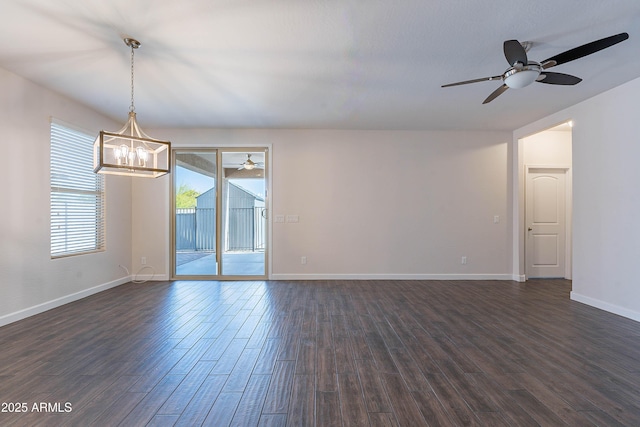 13523 W Remuda Dr, Peoria, AZ 85383 - spare room featuring a ceiling fan, a chandelier, dark wood-style flooring, and baseboards