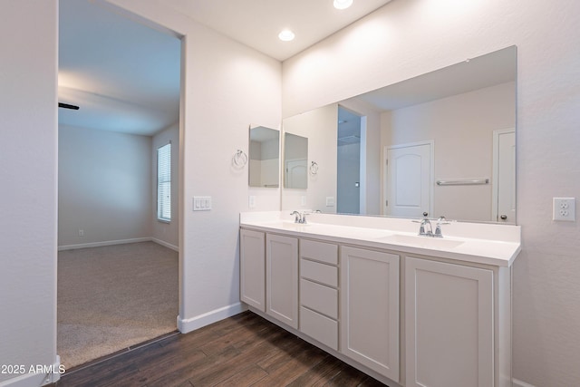 13523 W Remuda Dr, Peoria, AZ 85383 - bathroom with wood finished floors, double vanity, and baseboards
