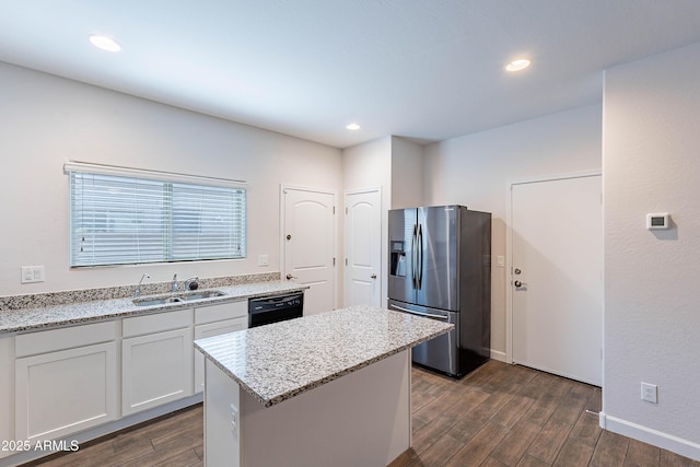 13523 W Remuda Dr, Peoria, AZ 85383 - kitchen with stainless steel fridge, a sink, dark wood finished floors, light stone counters, and a kitchen island