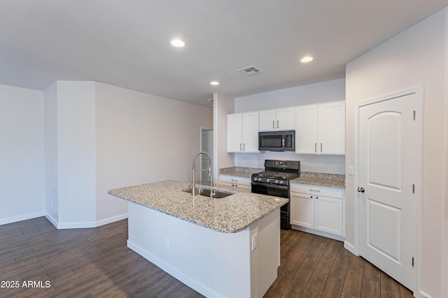 13523 W Remuda Dr, Peoria, AZ 85383 - kitchen with a sink, black gas stove, dark wood-type flooring, a kitchen island with sink, and light stone countertops