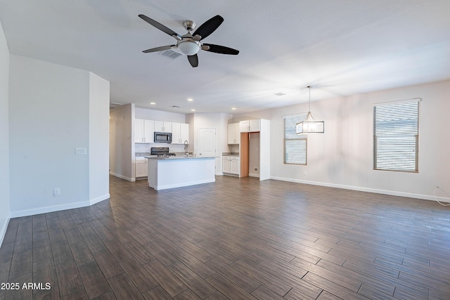 13523 W Remuda Dr, Peoria, AZ 85383 - unfurnished living room with a ceiling fan, baseboards, dark wood finished floors, recessed lighting, and a sink