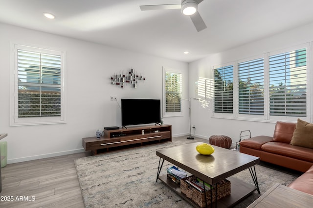 living room with ceiling fan and light hardwood / wood-style floors