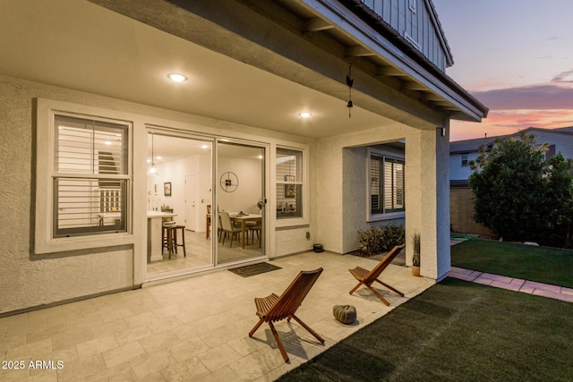 patio terrace at dusk with a yard