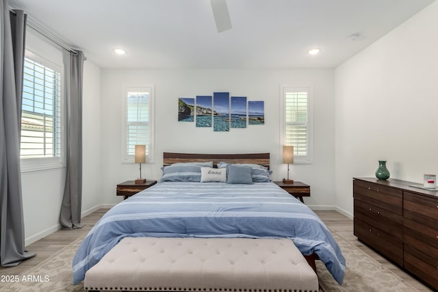 bedroom with light hardwood / wood-style flooring and multiple windows