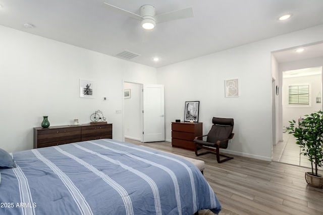 bedroom with light hardwood / wood-style floors and ceiling fan