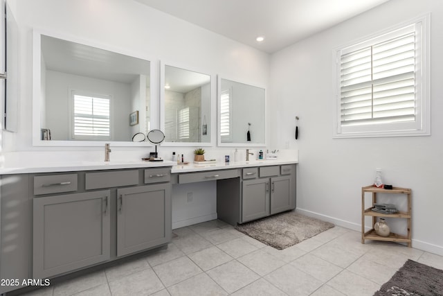 bathroom with a shower, tile patterned flooring, and vanity