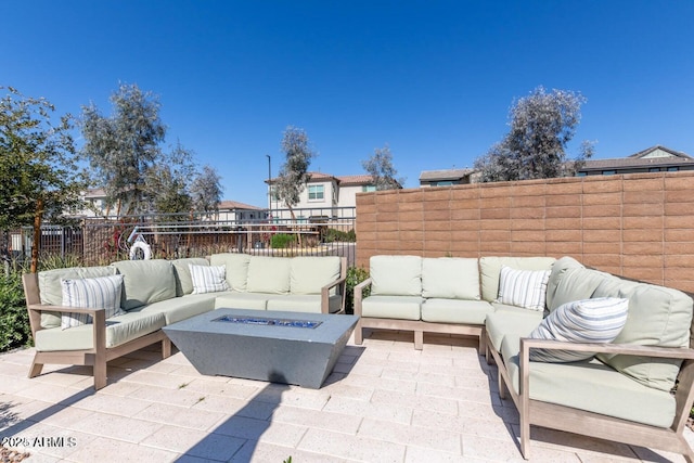 view of patio featuring an outdoor living space with a fire pit