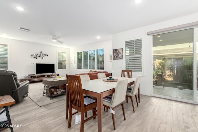 dining room with light hardwood / wood-style floors and ceiling fan