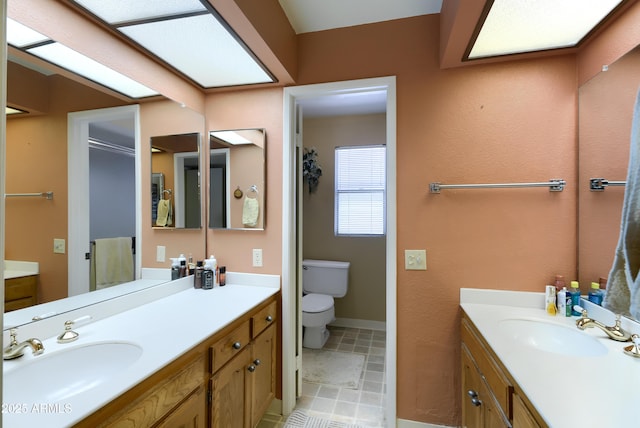 365 Leisure World, Mesa, AZ 85206 - bathroom with two vanities, toilet, and baseboards