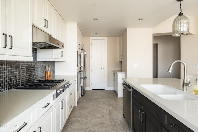 kitchen featuring under cabinet range hood, a sink, dark cabinets, white cabinets, and stainless steel appliances