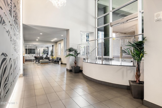 welcome area with a chandelier and a high ceiling