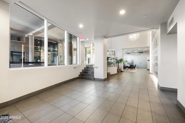 hall with tile patterned floors, stairway, baseboards, recessed lighting, and a chandelier