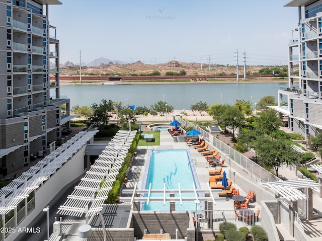 view of swimming pool with a water view
