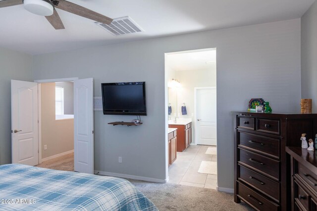 19937 W Heatherbrae Dr, Litchfield Park, AZ 85340 - bedroom with light colored carpet, connected bathroom, baseboards, a ceiling fan, and light tile patterned floors