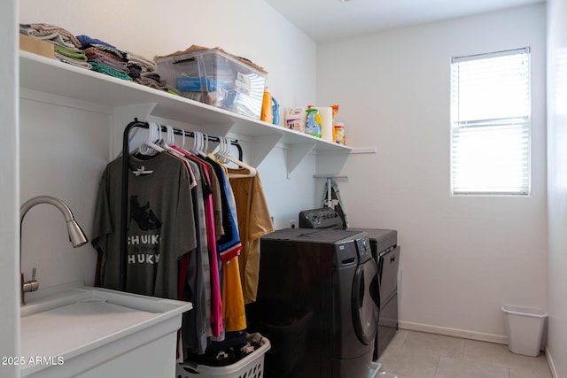 19937 W Heatherbrae Dr, Litchfield Park, AZ 85340 - washroom featuring separate washer and dryer, light tile patterned flooring, and baseboards
