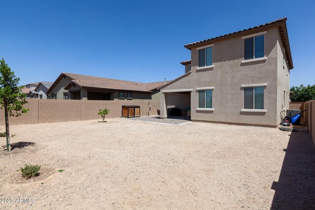19937 W Heatherbrae Dr, Litchfield Park, AZ 85340 - back of property with stucco siding, a fenced backyard, and a patio area
