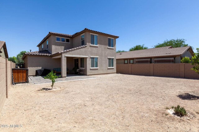 19937 W Heatherbrae Dr, Litchfield Park, AZ 85340 - back of property featuring stucco siding, a fenced backyard, a patio area, and a tiled roof