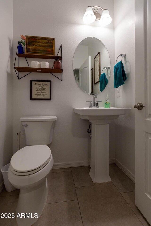 19937 W Heatherbrae Dr, Litchfield Park, AZ 85340 - half bath featuring tile patterned floors, toilet, and baseboards