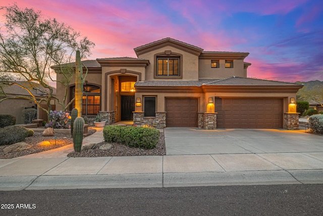 11124 N 138th Way, Scottsdale, AZ 85259 - mediterranean / spanish-style house featuring stucco siding, stone siding, driveway, a tiled roof, and an attached garage