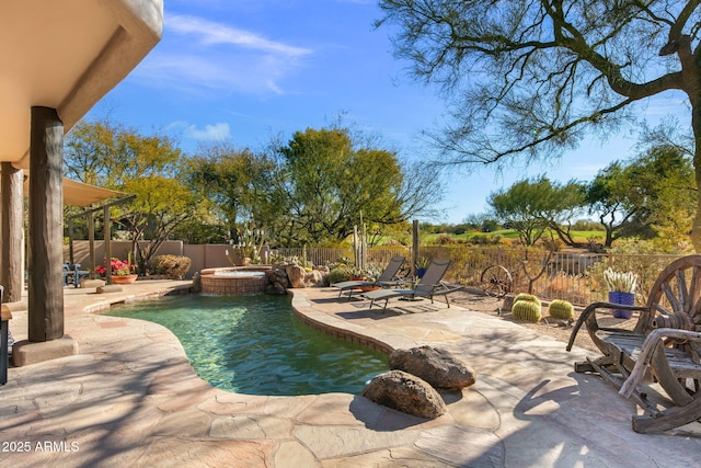 view of swimming pool featuring a fire pit, a patio area, and an in ground hot tub