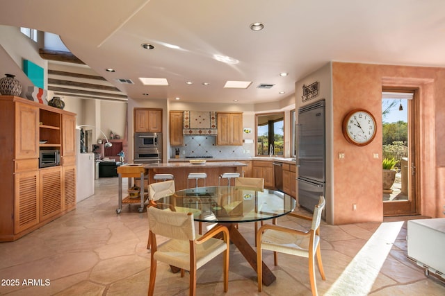 dining room with a skylight and plenty of natural light