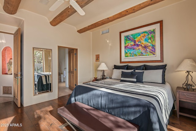 bedroom with dark hardwood / wood-style flooring, connected bathroom, beam ceiling, and ceiling fan