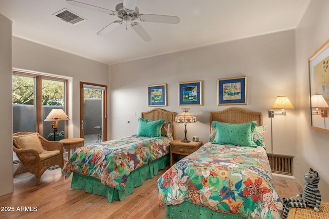 bedroom featuring hardwood / wood-style flooring, access to outside, and ceiling fan