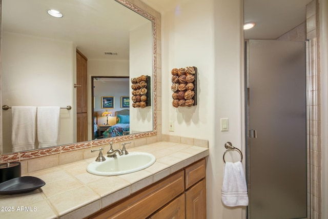 bathroom with an enclosed shower and vanity