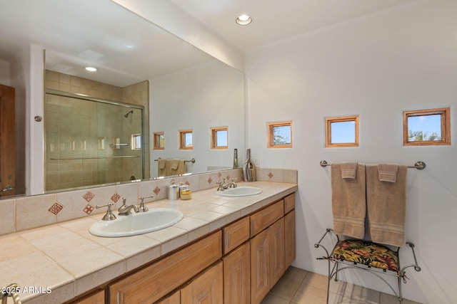 bathroom with tile patterned floors, vanity, and an enclosed shower