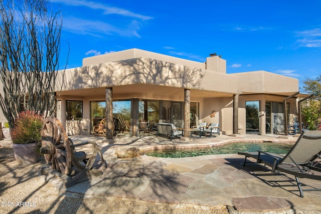 back of house with a patio