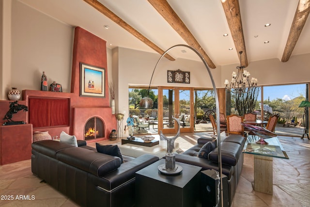 living room with beamed ceiling, an inviting chandelier, a fireplace, and french doors