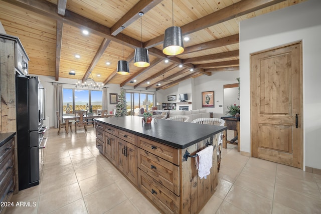 kitchen featuring black fridge, vaulted ceiling with beams, decorative light fixtures, a kitchen island, and wood ceiling