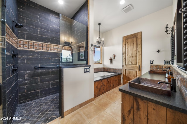 bathroom with tile patterned floors, vanity, separate shower and tub, and a chandelier